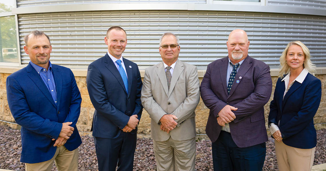 Five farmers in suits meeting in Ankeny, Iowa